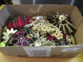 Cardboard jewellery box containing a quantity of various costume jewellery necklaces, bangles