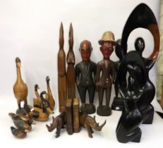 Group of seven African and other carvings, together with a quantity of other wooden carvings of