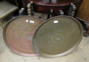 Two circular Benares brass tray top tables on turned folding stands