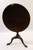 George III mahogany circular pedestal table, the tilt top above a vase turned column support and
