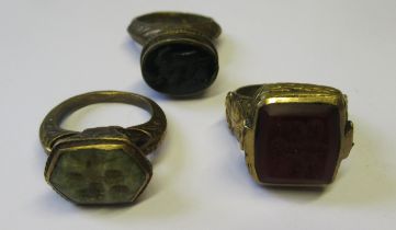Group of three antique gilt bronze rings with intaglio stones