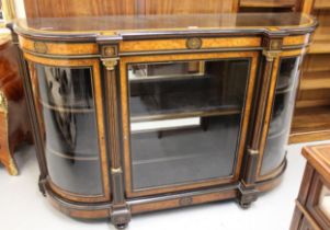 Victorian ebonised and amboyna banded credenza, the moulded top above a central glazed panel door