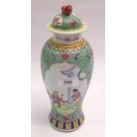 Chinese famille verte baluster form vase with cover decorated with panels of figures, signed with