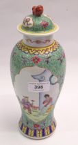 Chinese famille verte baluster form vase with cover decorated with panels of figures, signed with