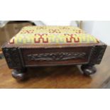 Low rectangular footstool with carved applied decoration on bun supports and a two handled log