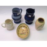 Ashtead Potters two blue glazed jugs, 17cm high, another smaller jug in white, a vase decorated with