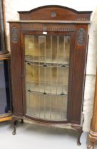 Early 20th Century mahogany semi bow front display cabinet, the leaded glass door with Art Nouveau