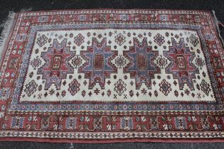 Modern Turkish rug with a repeating medallion design in shades of pink, blue and cream, 192 x 128cm