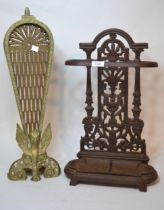 Brass folding firescreen of peacock design, and a modern patinated cast iron stick stand with drip