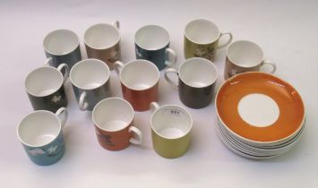 Collection of Susie Cooper coffee cups and saucers of various colours with floral decoration