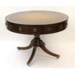 Late 19th / early 20th Century mahogany circular drum table having brown leather and gilt tooled
