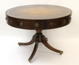 Late 19th / early 20th Century mahogany circular drum table having brown leather and gilt tooled