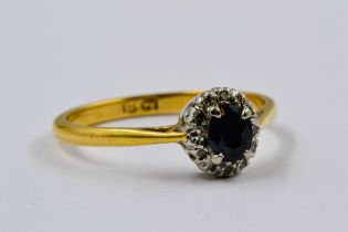 18ct Yellow gold ring set with sapphire surrounded by diamonds, sapphire 4mm x 6mm, size 'O', 2.5g