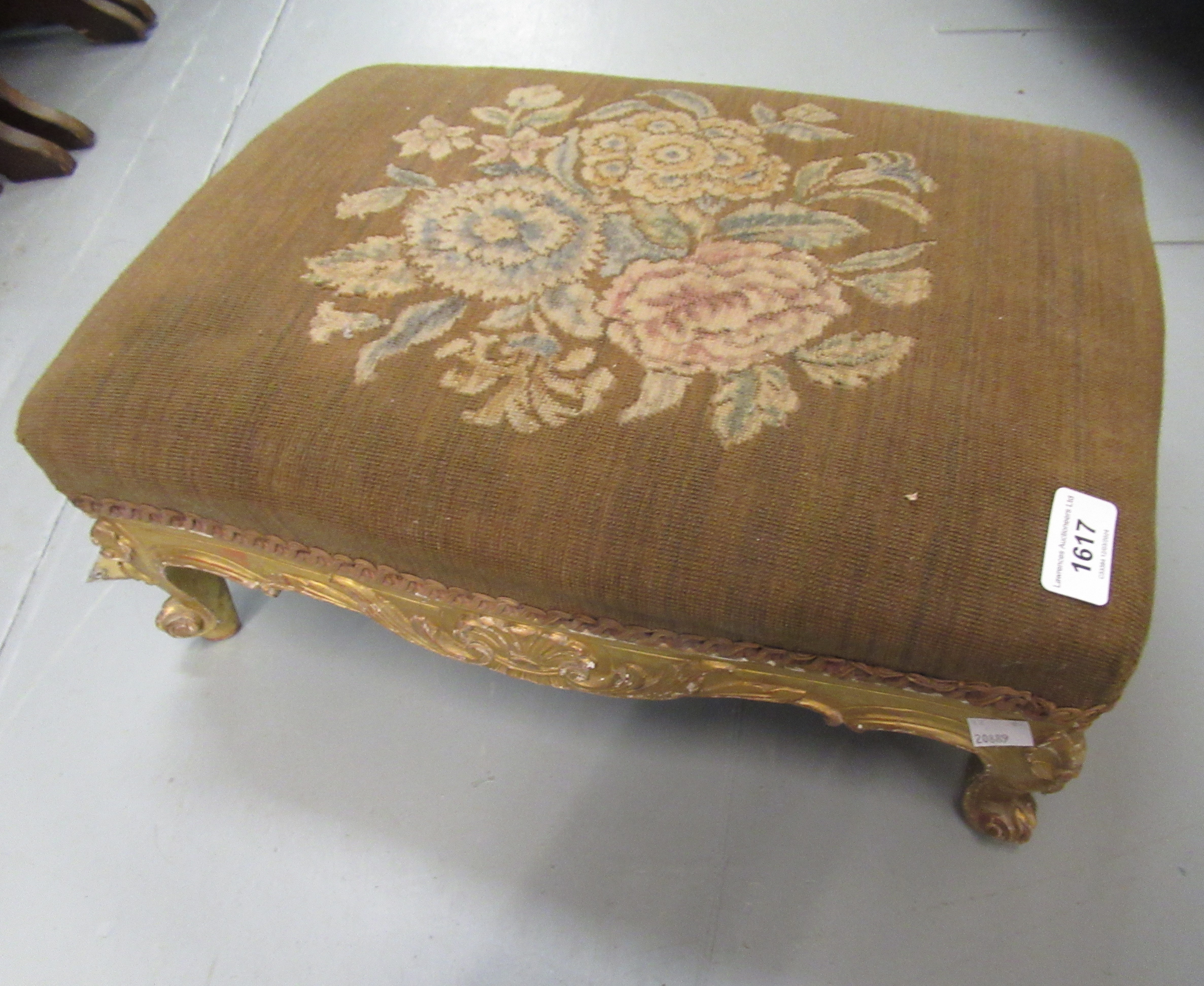 Small Victorian giltwood footstool with floral decorated top on cabriole supports, 44cm wide