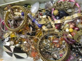 Tin containing a quantity of various costume jewellery including bracelets etc.