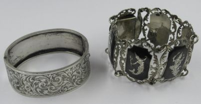 Silver floral engraved bangle, together with a Thai white metal bracelet