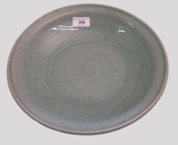 Chinese Celadon circular deep dish with shallow incised decoration, 32cm diameter, with a hardwood