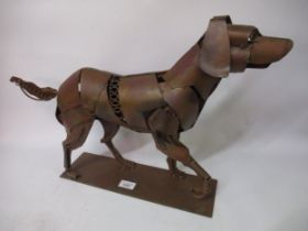 Patinated metal abstract figure of a dog, 60cm long