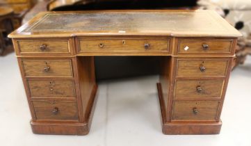 Small 19th Century mahogany inverted breakfront pedestal desk, having an arrangement of nine drawers