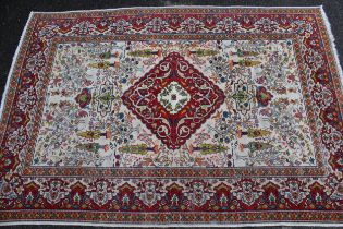 Small Indian rug with a medallion and all-over animal and garden design on an ivory ground with