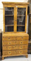 18th Century and later walnut two door bookcase, having moulded top with adjustable shelves, the