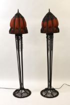 Pair of late 20th Century dark patinated wrought iron and mottled glass floor lamps of Arts and