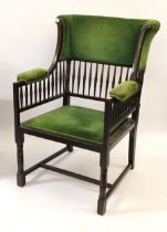 Arts and Crafts mahogany wing armchair with upholstered and spindle back above a padded seat and