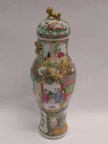 19th Century Canton baluster form vase and cover decorated with typical figures and flowers, 33cm