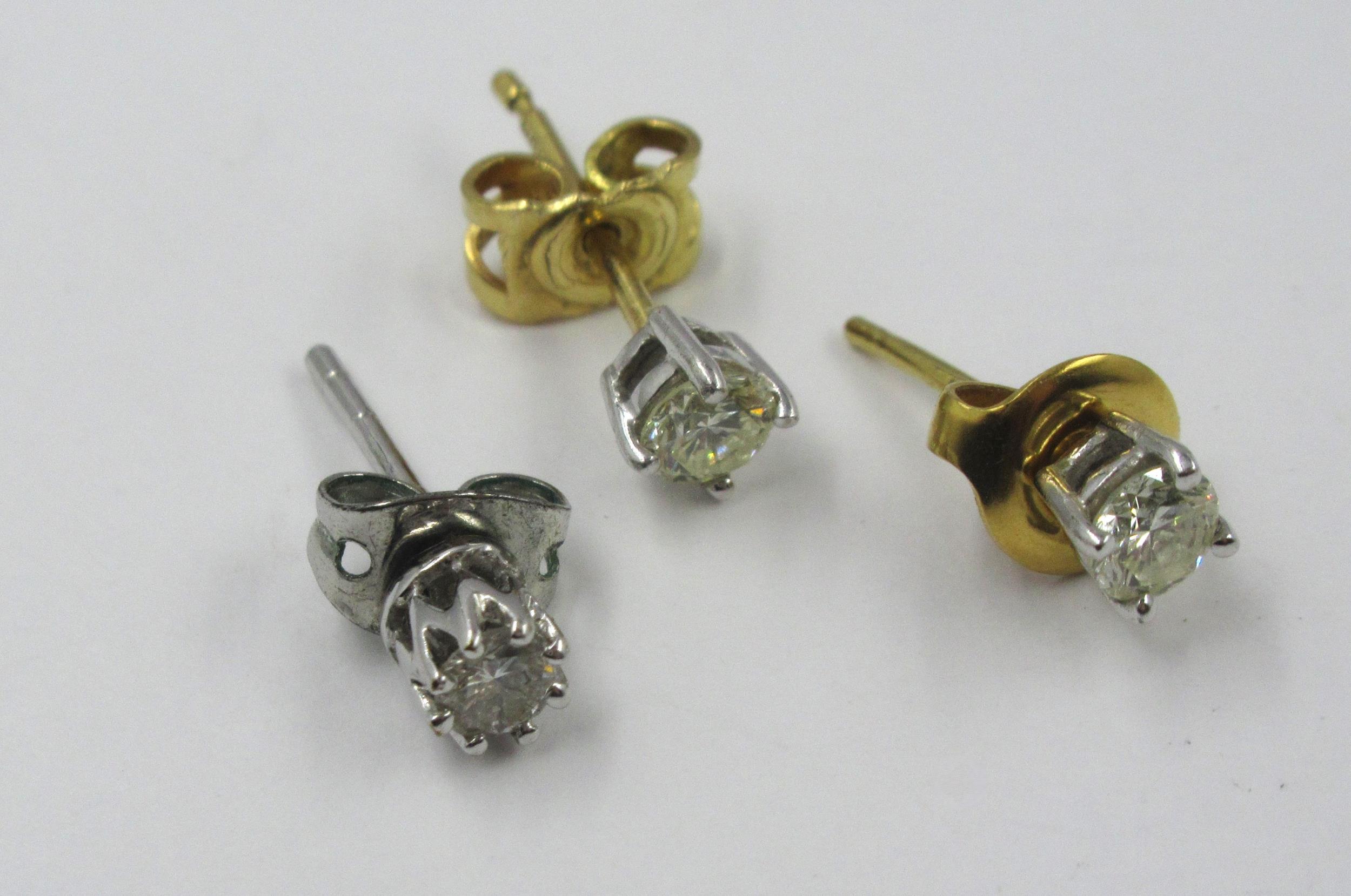 Group of three various solitaire diamond ear studs