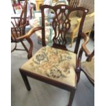 George III mahogany open armchair with a pierced splat back, shaped arms, needlepoint drop-in seat