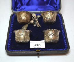 Cased set of four embossed silver open salts, 2oz t, together with one silver salt spoon and various