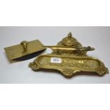 Brass ink stand decorated with cherubs, a paper knife and a brass mounted ink blotter