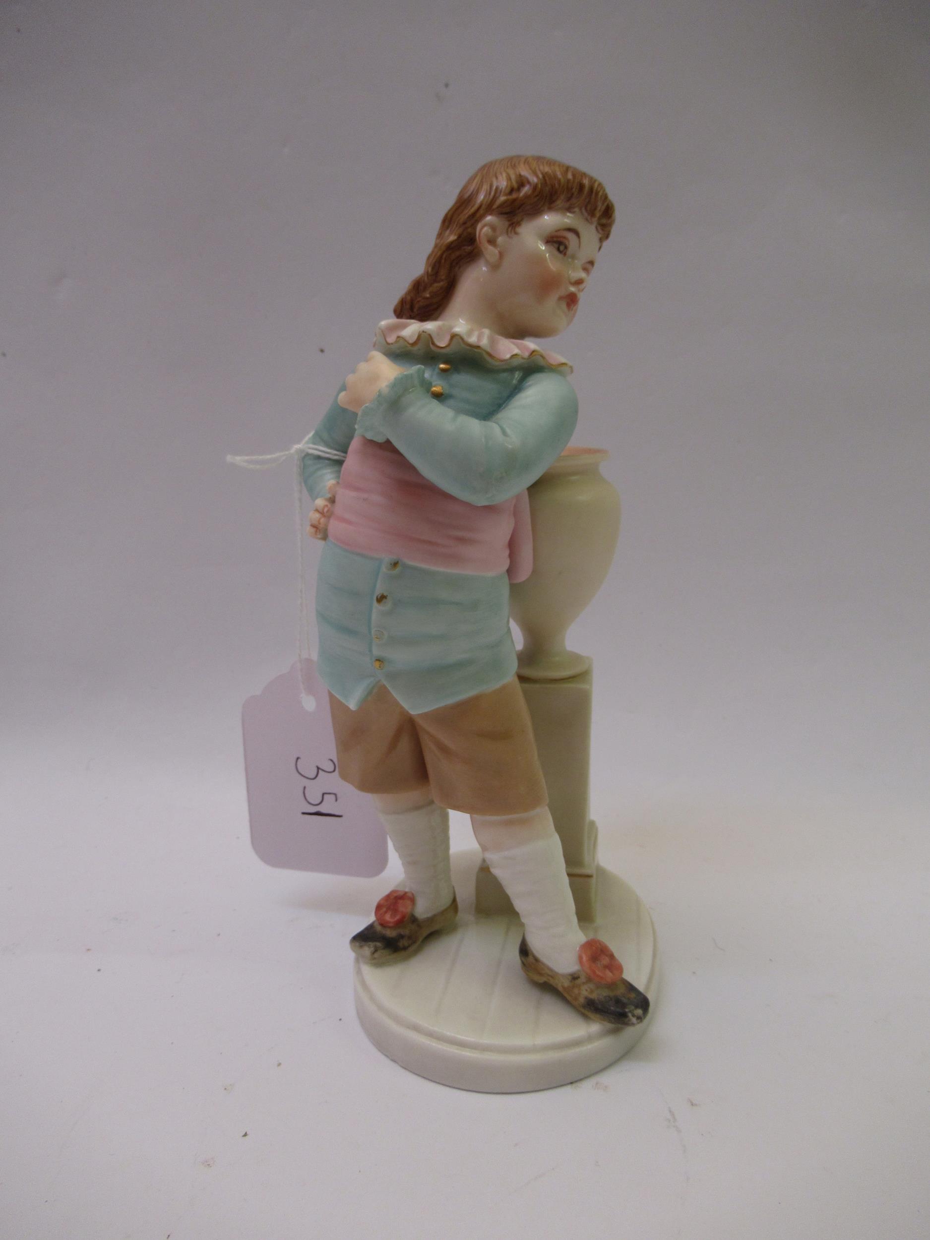 Royal Worcester porcelain figure of a boy leaning against a column with a vase, 17cm high