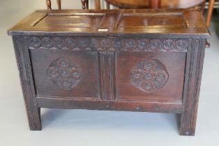 Small 17th Century oak coffer, the hinged two panel lid above a carved frieze and two panel front on