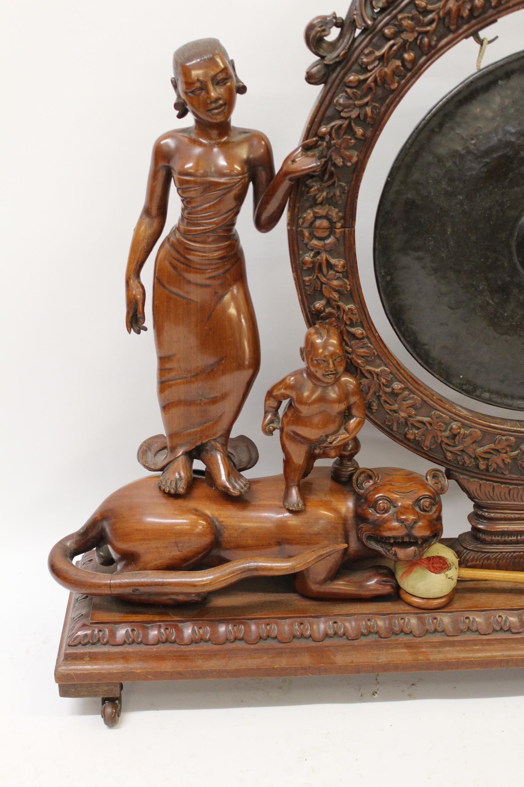 Very large Indonesian carved hardwood gong on stand, the central circular support with profuse all- - Image 2 of 3