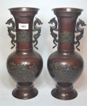 Pair of Japanese brown patinated bronze two handled vases with relief moulded bird and floral