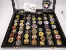 Collection of American Police Department medallions, housed in an ebonised wall cabinet