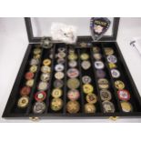 Collection of American Police Department medallions, housed in an ebonised wall cabinet