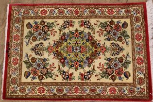 Small modern oriental silk rug with a medallion and floral spring design on an ivory ground with