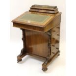 Victorian figured walnut Davenport with a stationery compartment above a hinged sloping writing