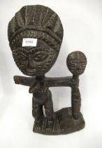 African native carved hardwood figure with a maskhead staff, 41cm high