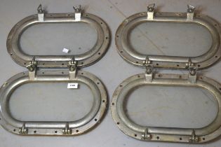 Set of four silvered metal oval porthole covers, each approximately 44 x 27cm