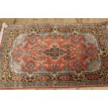 Indian rug with a medallion and all-over floral design on a rose ground with borders, together