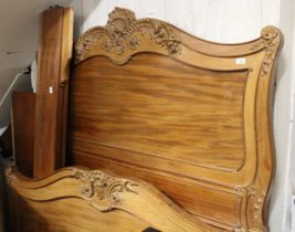 19th Century French walnut king size bed having carved decoration and plain side rails, with base (