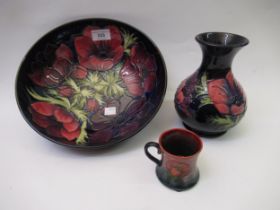 Modern Moorcroft bowl in the Anemone pattern with dark blue ground, together with a similar baluster