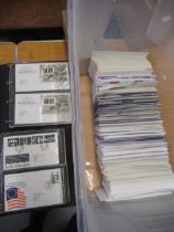 Two black albums containing a quantity of First Day covers and a large quantity of loose First Day