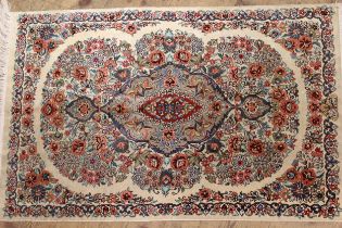 Modern oriental silk rug with a lobed medallion and all-over stylised floral design on an ivory