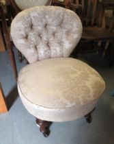 Victorian walnut low seat nursing chair with button upholstered damask fabric, on turned reeded
