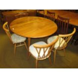 Ercol light ash circular drop-leaf dining table, on splayed supports, 72cm high x 113cm diameter,