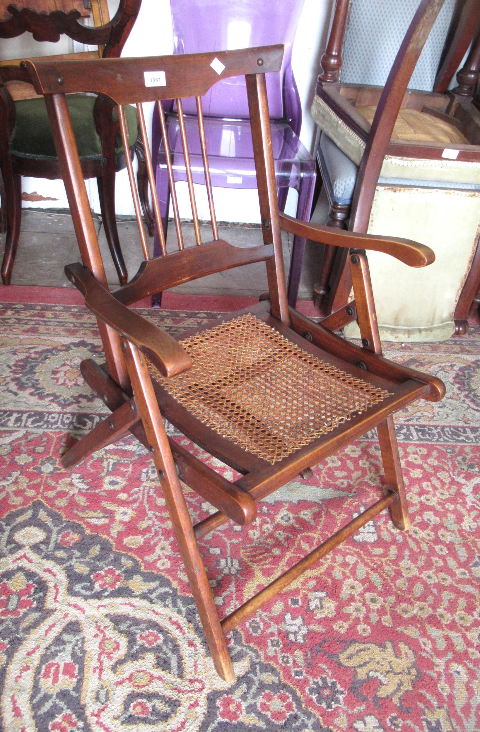 Late 19th / early 20th Century folding campaign chair with a spindle back and cane seat